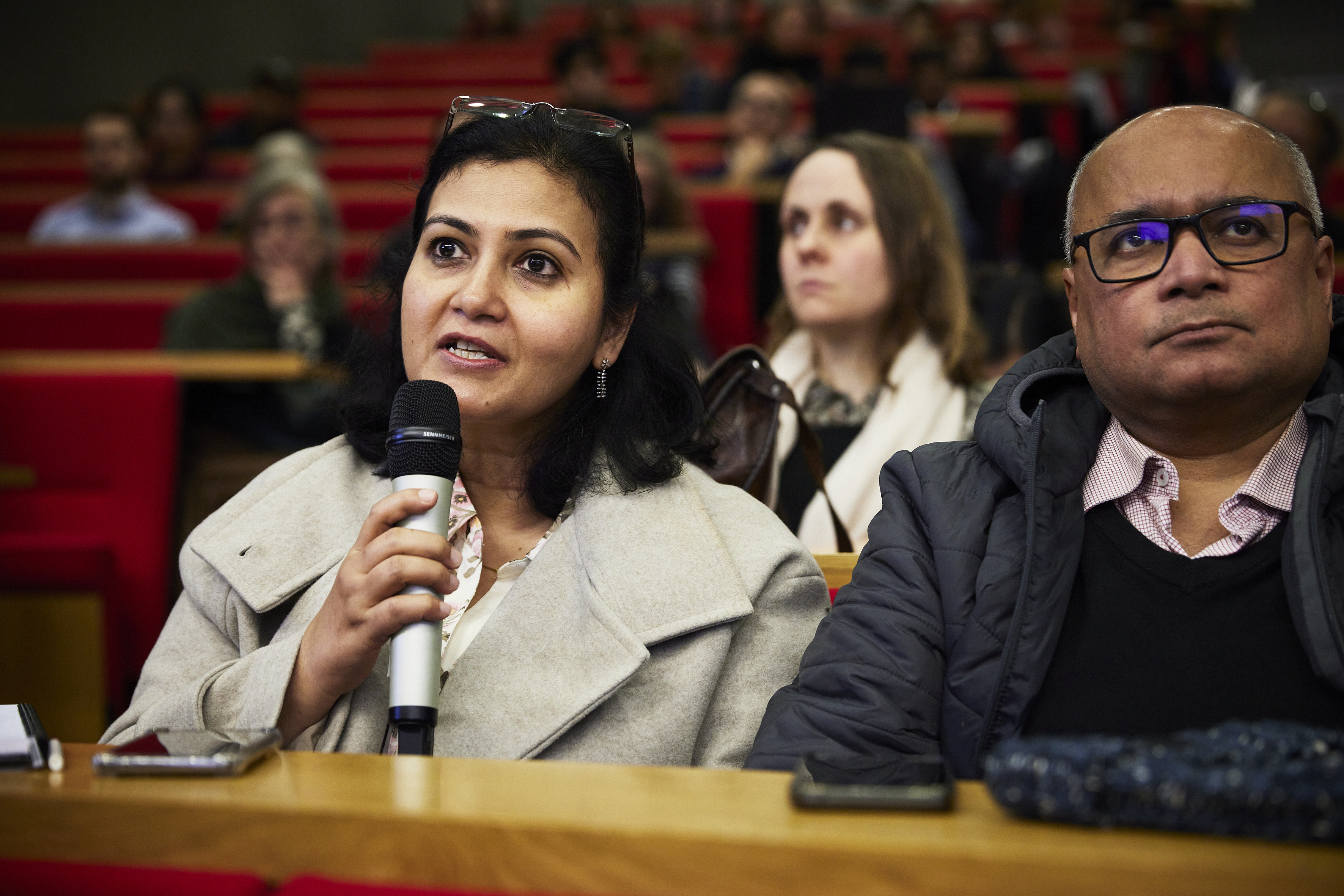 A woman in the audience asks a question at the Alex Edmans book launch event